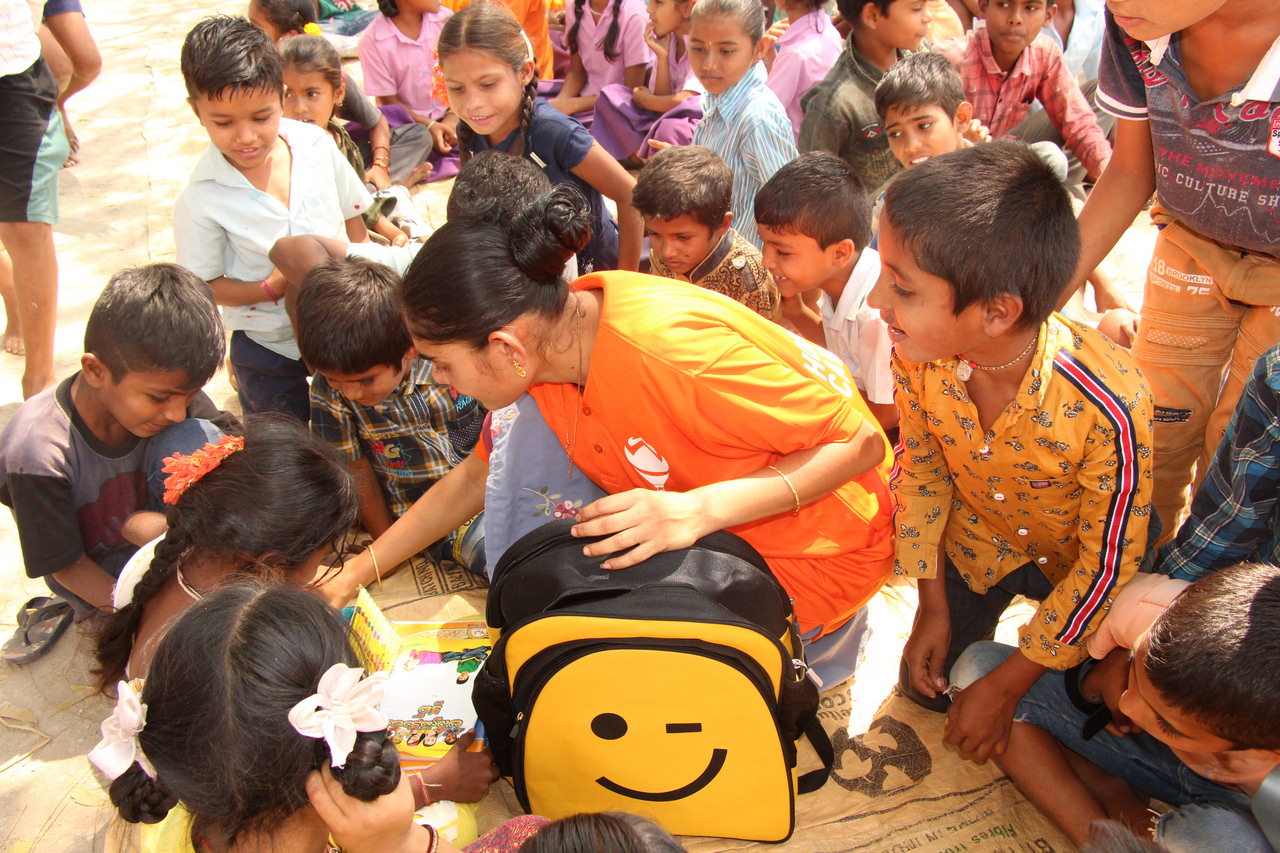 A Hope Carrier volunteer takes a child through her backpack’s contents