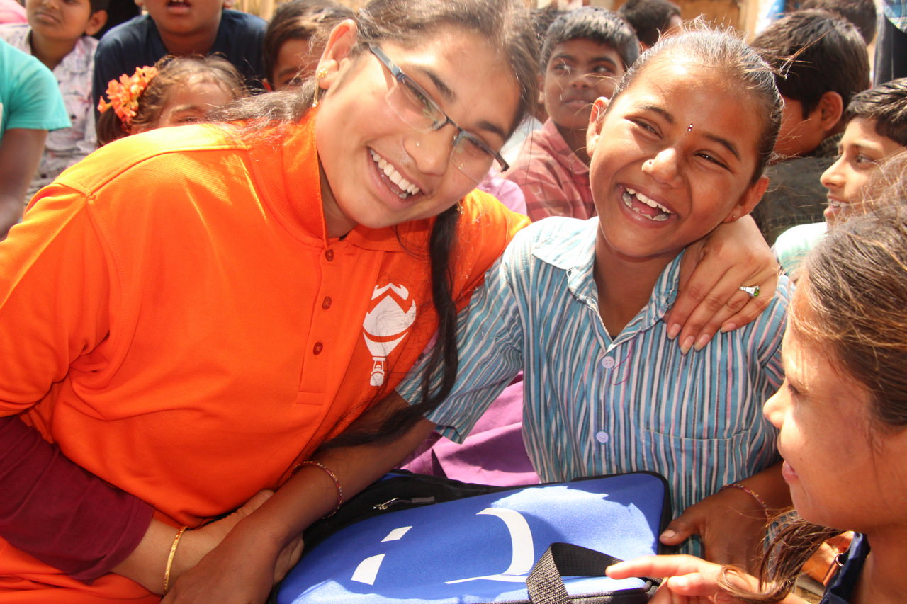 A Hope Carrier volunteer shares a sweet moment with a local girl