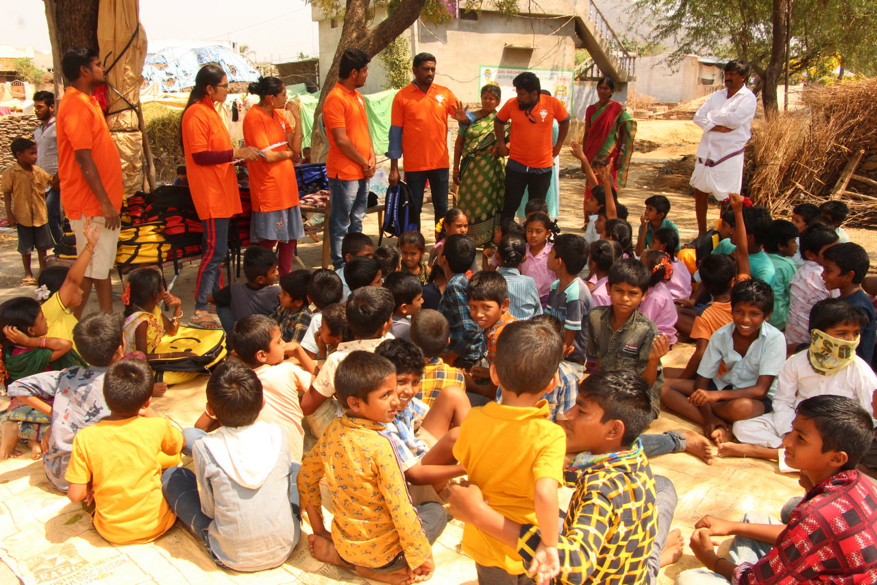 Children listening to the story of Jesus as they wait for their backpack