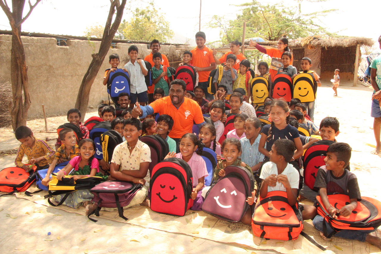 Some of the children pose with our Hope Carrier volunteers after receiving their backpacks