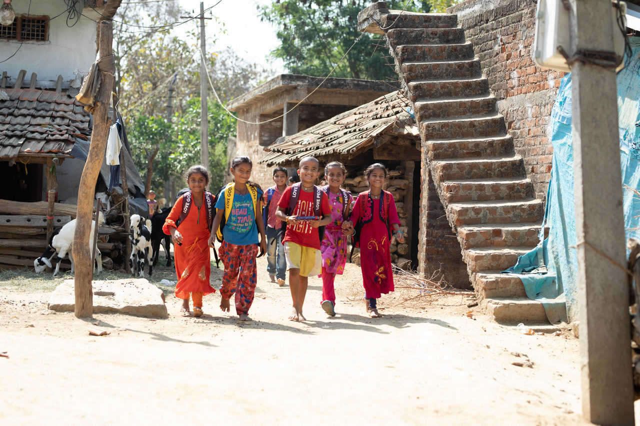 A group of children head home after a successful, joyful distribution