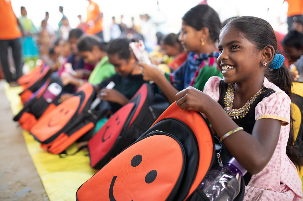 Unabashed cheer as children go through their backpacks for the first time 