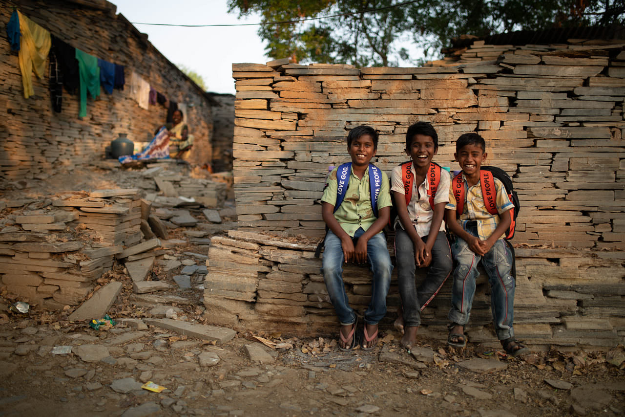 Three boys enjoy a chat after the distribution