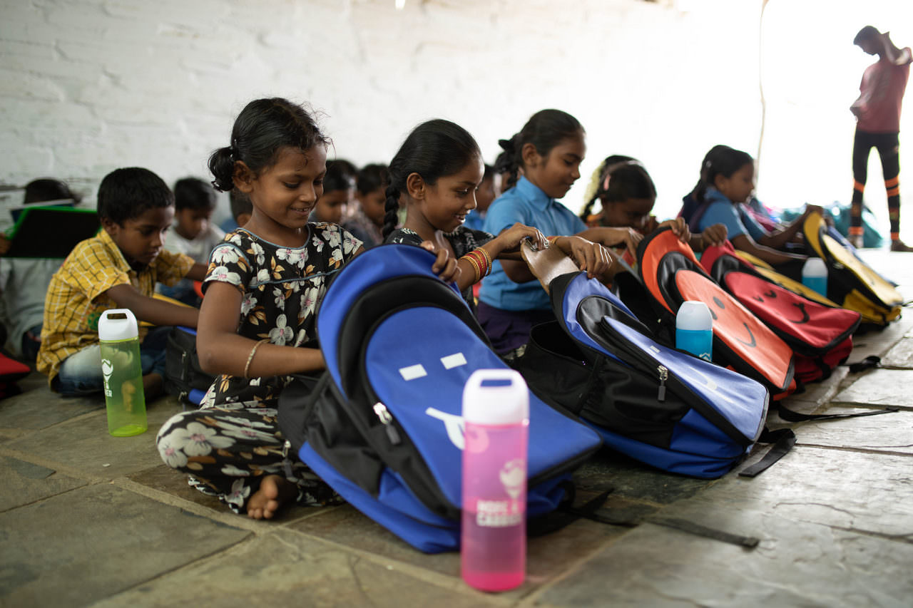 Unabashed cheer as children go through their backpacks for the first time 